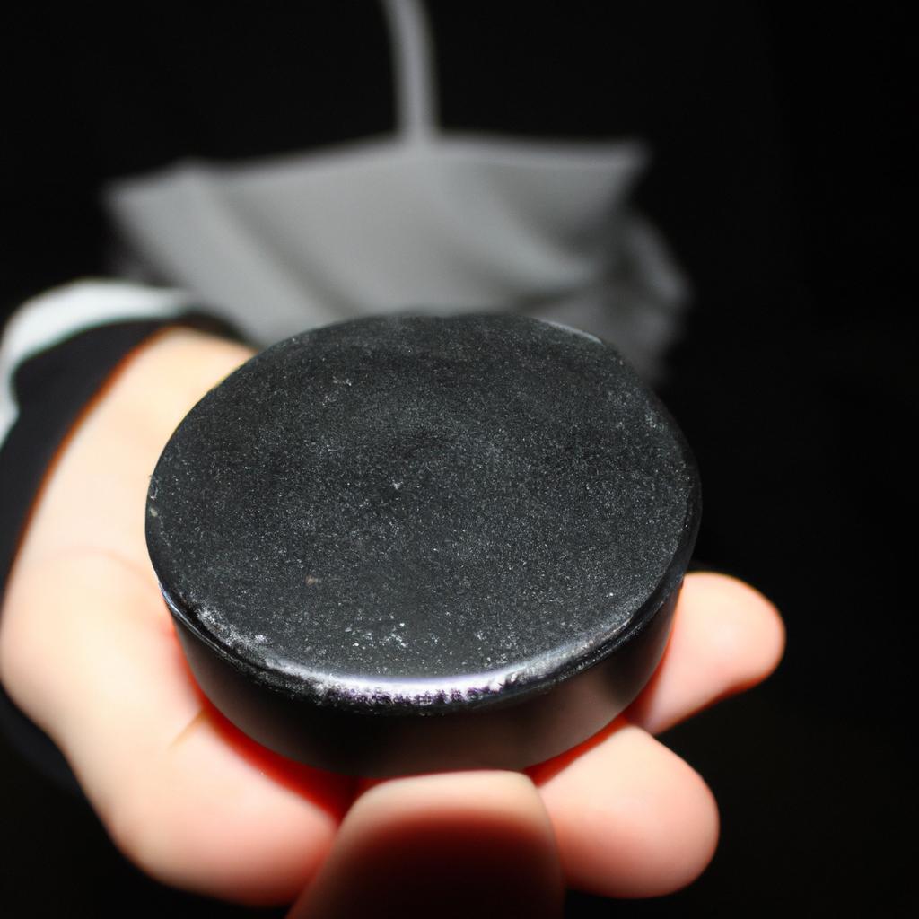 Person holding ice hockey puck